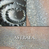 Collage showing Astraea loose and swatched on the skin. soft blue-grey toned highlight powder with a celestial gold shift and shimmer