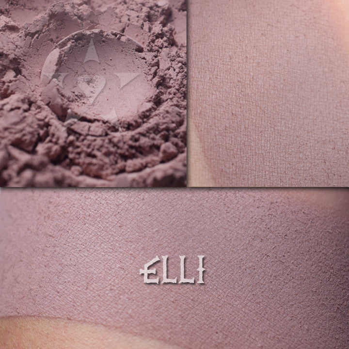 Elli matte finish eyeshadow shown loose and swatched on the skin. Muted mauve heather with grey undertones