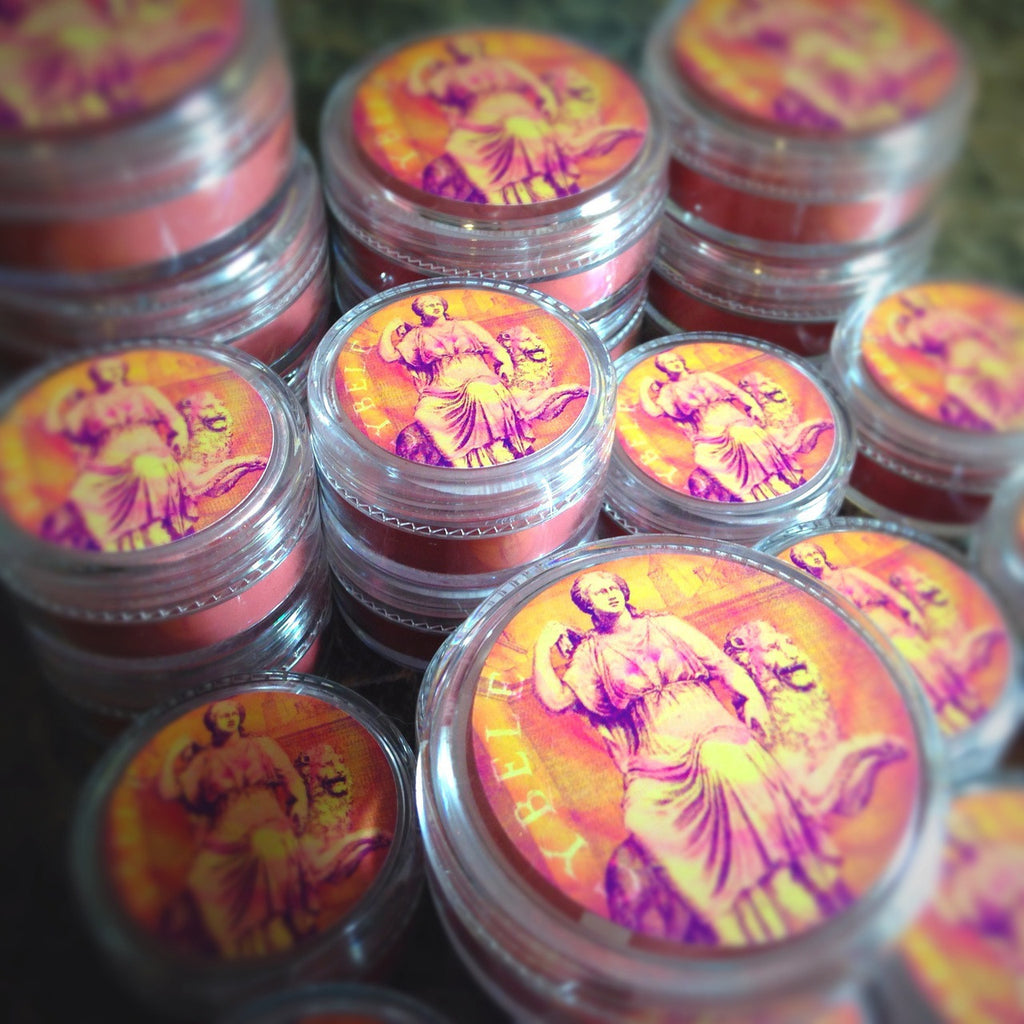 CYBELE rouge loose and swatched on the skin,. a gorgeous berry red with a strong gold/copper shift