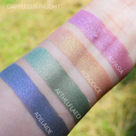 Neat skin swatches of Adelaide and several other eyeshadows. Adelaide is the first swatch, Image of swatches on skin of Adelaide eyeshadow. Adelaide is a rich violet-blue with multi-tonal overlays of rose and violet.