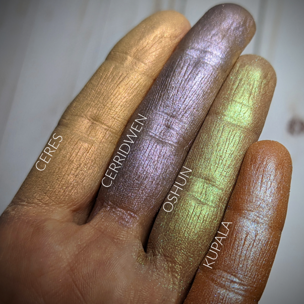 KUPALA- HIGHLIGHTER  loose and swatched on the skin. Kupala multipurpose/highlighter shade is a rich warm bronzey peach with a satiny blue highlight.