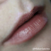 Closeup of caucasian woman's lips wearing Spirits Wept, reddish brown lip cream.
