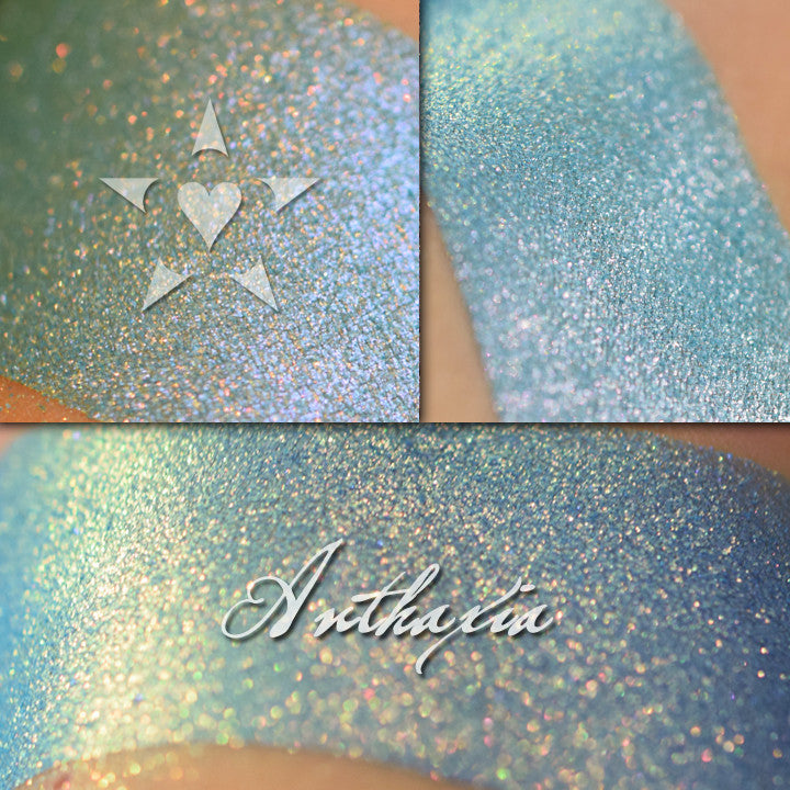 ANTHAXIA  eyeshadow swatched on the skin in three views. r  A vibrant blue with red to gold shift depending on lighting conditions, it can also appear as a violet shift since the red iridescence is affected by the blue base. 