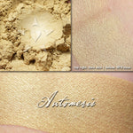 AUTOMERIS - Multipurpose highlighter/eyeshadow  loose and swatched on the skin. A pale buttery cream/gold.