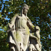 Stone statue covered with green moss depicting Aethelflaed, who this eyeshadow shade is named after.