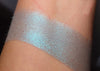 AMERAUCANA eyeshadow swatched on the skin, A pale/medium heathered grey blue with a strong teal/blue shift.