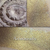ARISTOCRATIC - EYESHADOW shown in a collage, loose and swatched on the skin. Gray/Taupe with strong golden glow.