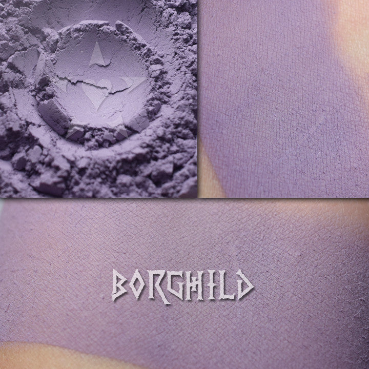 Borghild matte eyeshadow shown in a collage. Loose and swatched on the skin.  Midtone, slightly muted violet.