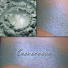 CREVECOEUR - EYESHADOW loose and swatched on the skin. A pale/medium heathered green with a strong purple shift.
