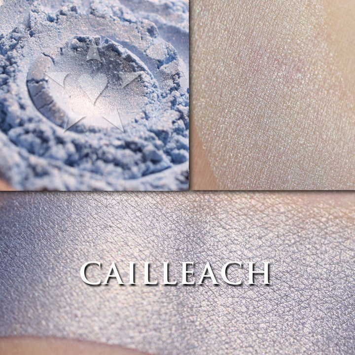 CAILLEACH - highlighter  loose and swatched on the skin. Cailleach is a delicate and heathered pale blue with a copper highlight
