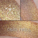 CRUEL FATES - EYESHADOW loose and swatched on the skin. Coppery brown shifting to vibrant gold and greenish gold, as well as to a stronger copper.