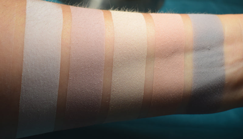 Skin swatches of matte eyeshadow on inner arm of medium tone caucasian skin. 