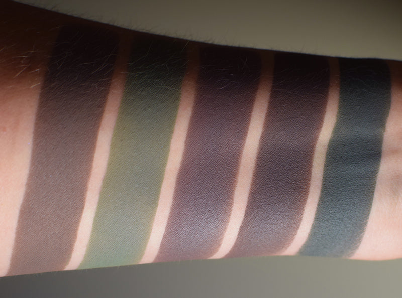 Inner arm showing skin swatches of deeper toned matte eyeshadows. Bestla is second from the left, a deep olive khaki matte.