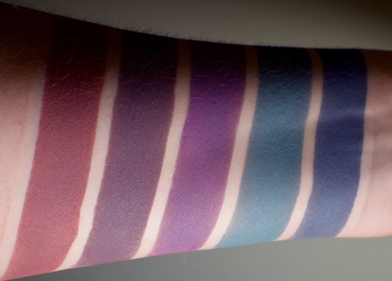 Skin swatches shown on inner arm of deep matte colors from this collection. 