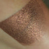 Skin swatch of Lozen, It is a deep chocolate brown with copper to red to violet chrome effects.