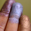 Fingertip swatches of frost eyeshadows. It is a deep chocolate brown with copper to red to violet chrome effects.