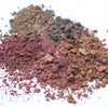 Piles of loose makeup in various earth tones.