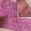 EURYDICE - EYESHADOW loose and swatched on the skin. A jewel-toned burgundy that flashes to fuchsia and also copper. 