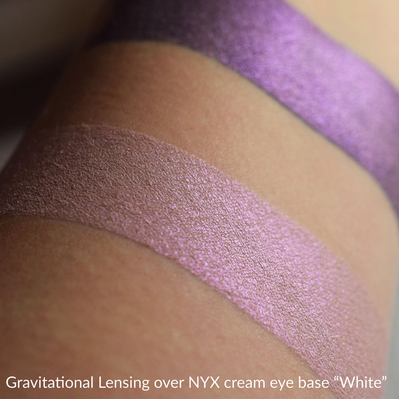 GRAVITATIONAL LENSING  over white cream ehye base.
