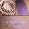GRAVITATIONAL LENSING - MULTI/HIGHLIGHTER loose and swatched on the skin. has a buff base with a purple glow. 