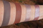 Contour and highlight powders swatched on the inner arm.