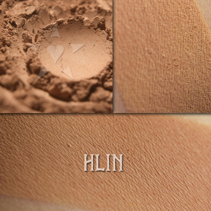 Hlin matte finish eyeshadow shown loose and swatched on skin. Muted terracotta, peachy-soft brown