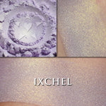 IXCHEL highlighter loose and swatched on the skin. Ixchel highlighter is a pale lavender with gold shift/glow.