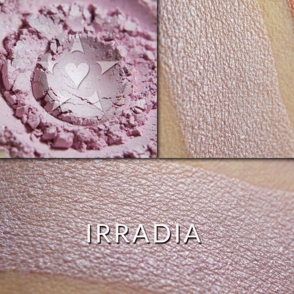 IRRADIA - Multipurpose Illuminator loose and swatched on the skin.  IRRADIA: A sheer glow of sweet pink with a delicate gold highlight.