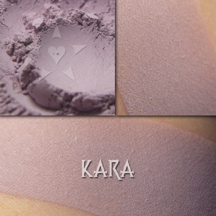 Kara matte eyeshadow shown loose and swatched on the skin. Pale muted lilac.