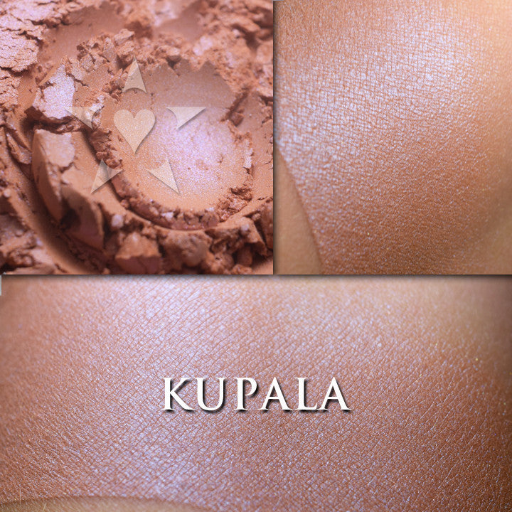 KUPALA- HIGHLIGHTER  loose and swatched on the skin. Kupala multipurpose/highlighter shade is a rich warm bronzey peach with a satiny blue highlight.