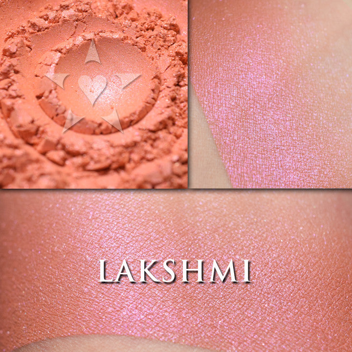 LAKSHMI loose and swatched on the skin. a gorgeous coral/orange with a warm purple shimmer.