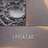 Loviatar shown loose and swatched on the skin. Medium-deep blue-gray. Matte finish.