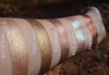 Earth toned frost eyeshadows swatched on medium tone caucasian skin. Coppery brown shifting to vibrant gold and greenish gold, as well as to a stronger copper.