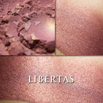 LIBERTAS  rouge loose and swatched on the skin. a cool red/mauve with golden sheen.