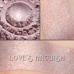 LOVE'S ANGUISH - Highlighter loose and swatched on the skin. a beautiful muted lilac highlighter with metallic copper sheen.