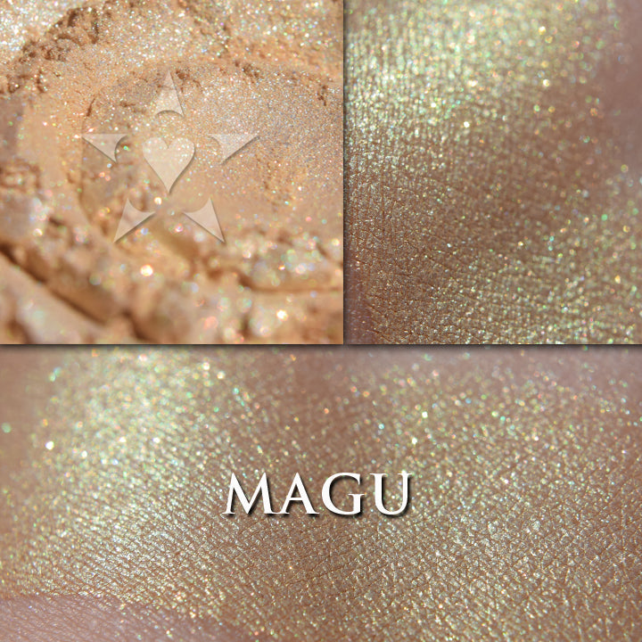 Magu highlighter loose and swatched on the skin.  This highlighter has a copper and green shimmer, and slight greenish glow with a creamy yellow base