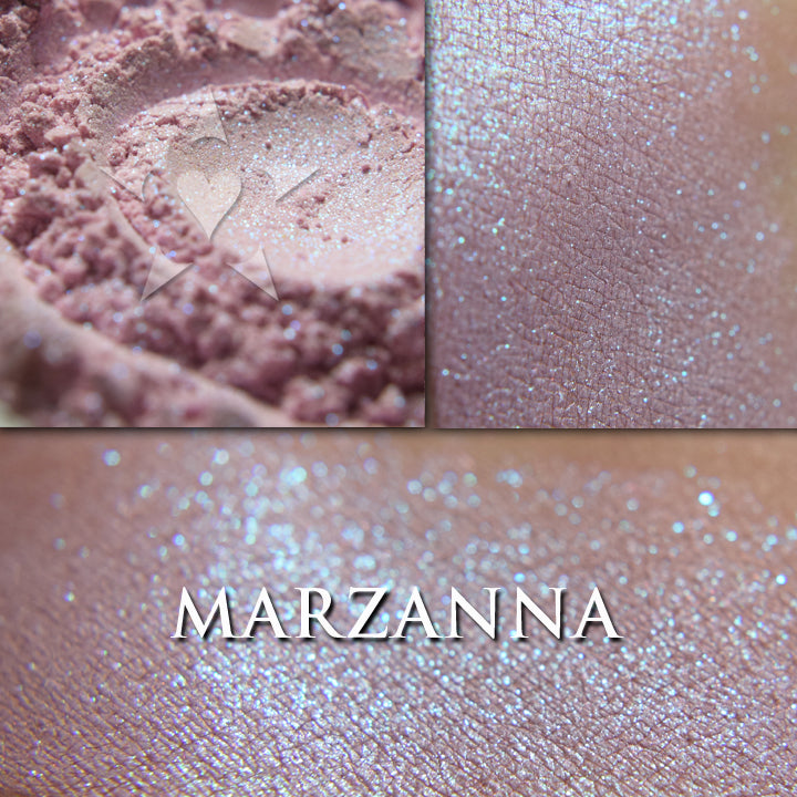 Marzanna loose and swatched on the skin. a sheer cool pink base with blue to teal shimmers. 