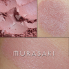 MURASAKI rouge shown loose and swatched on the skin. Murasaki is a soft buff pink. 