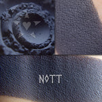 Nott matte eyeshadow shown loose and swatched on the skin. Deep blackened navy