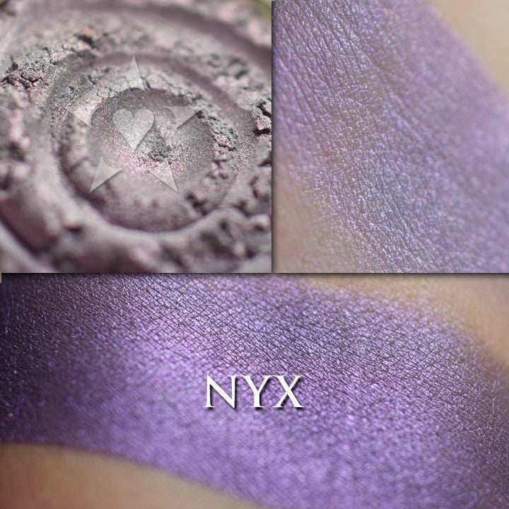 Nyx loose and swatched on the skin, It has a soft smoke base with a rich violet iridescence. I