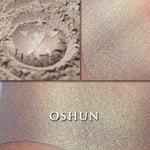 Oshun highlighter loose and swatched on the skin. Oshun is a soft metallic bronze highlighter or bronzer with a teal interference highlight. 