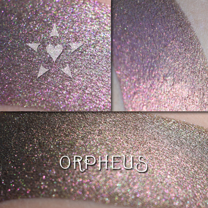 ORPHEUS - EYESHADOW loose and swatched on the skin. a deep warm green base with a shifting overlay of purple to rose to copper and sometimes more golden tones.