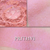 Prithvi rouge loose and swatched on the skin. PRITHVI, a soft and wearable pale coral peach with delicate inner glow.