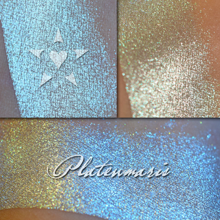 PLATEUMARIS - Vintage Aromaleigh Eyeshadow swatched on the skin in three views.  A metallic silver base with green to teal to blue color travel. 