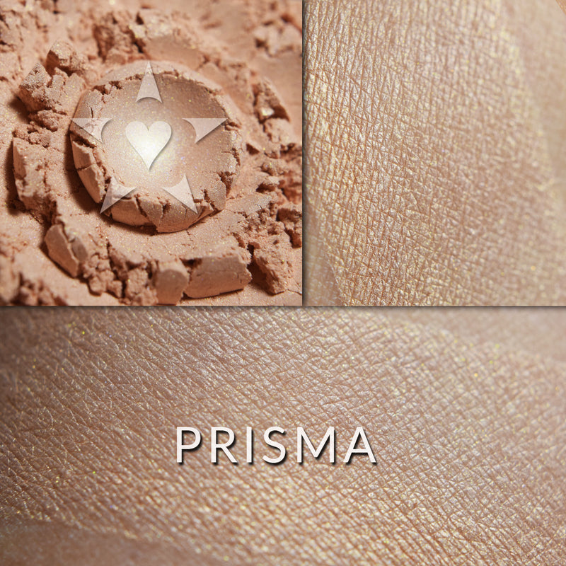 Prisma illuminator loose and swatched on the skin.  PRISMA- A sheer, soft glowing coral with a touch of buff undertones.