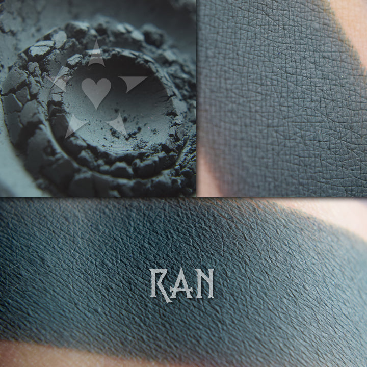 Ran matte eyeshadow shown loose and swatched on the skin. Deep heathered teal