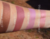 Rouge shades swatched on the inner arm.