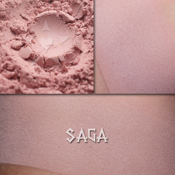 Saga matte eyeshadow shown loose and swatched on the skin. Soft petal pink