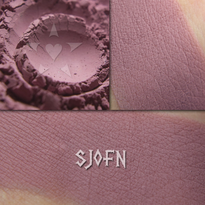Sjofn matte eyeshadow shown loose and swatched on the skin.  Midtoned heathered mauve