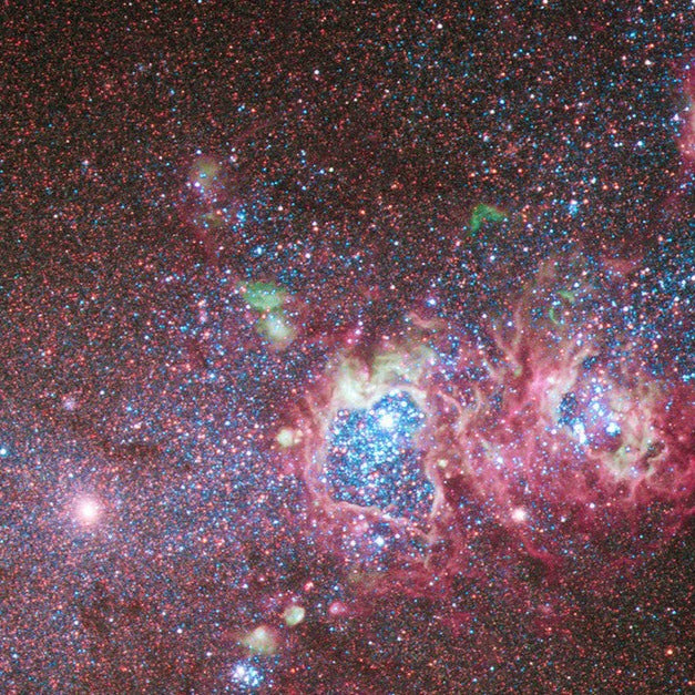 Space image depicting red pink and white clusters of stars.